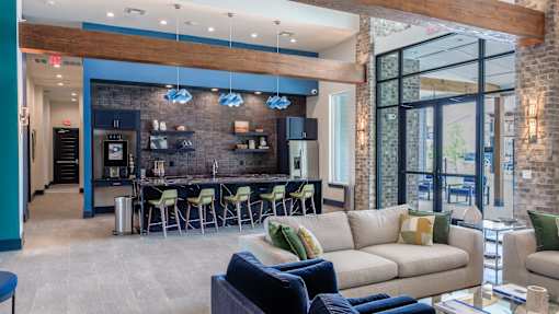 A modern living room with a bar area and a view of the outdoors.